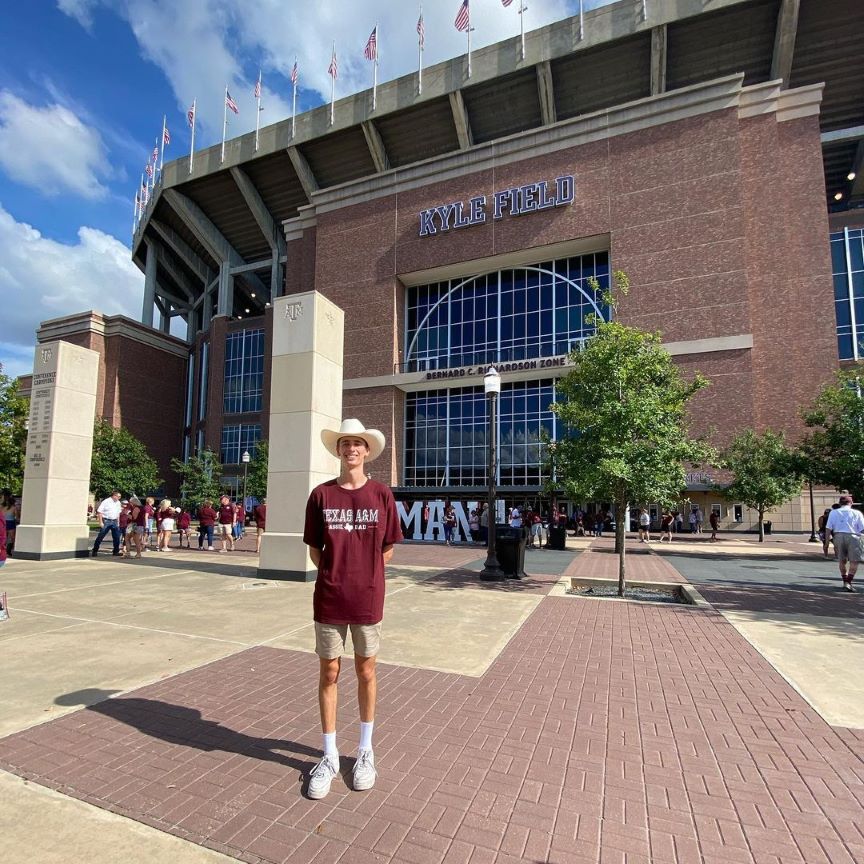 student standing in front of building