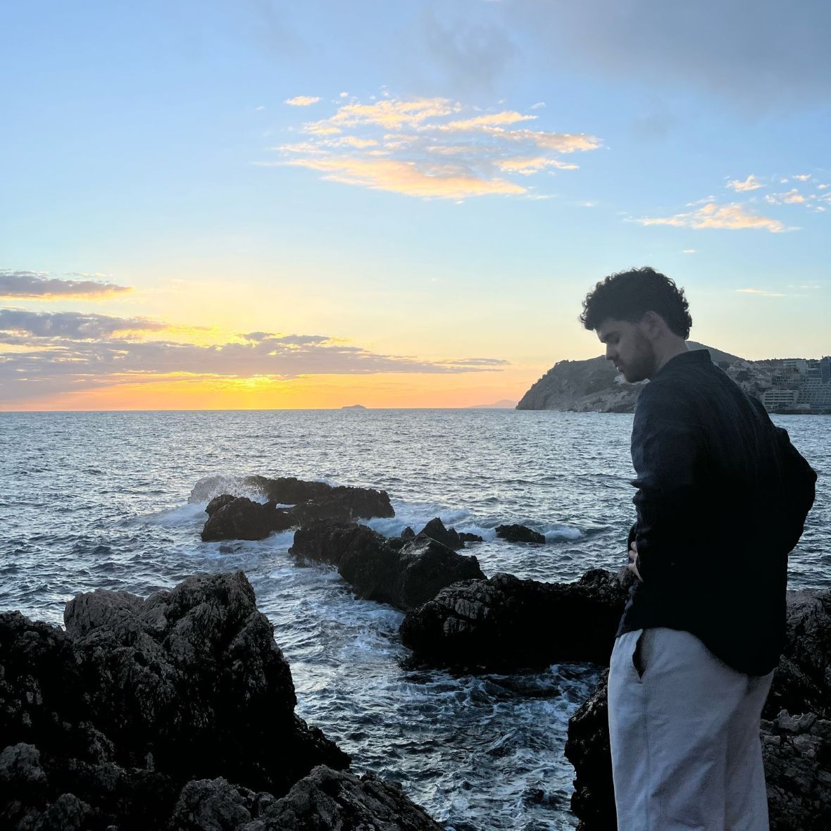 Student looking over sea and sunset in Belgium. 