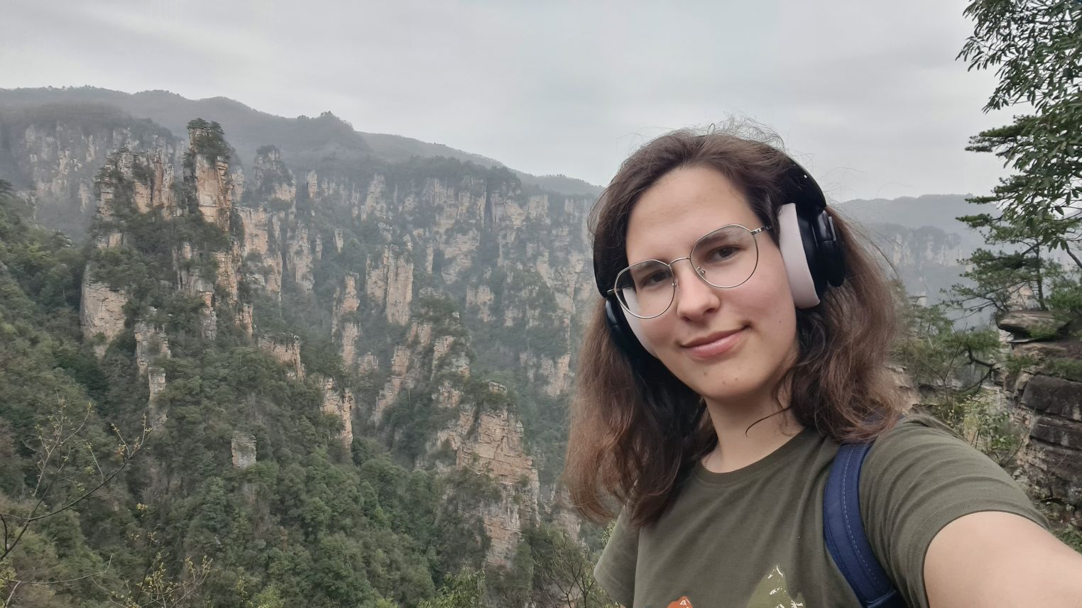 Student standing in front of Hong Kong landscape 