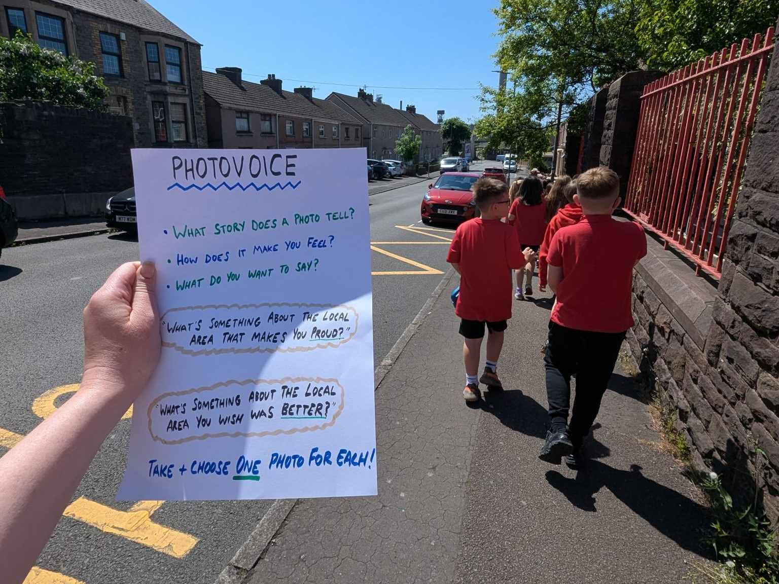primary school students walking down pavement