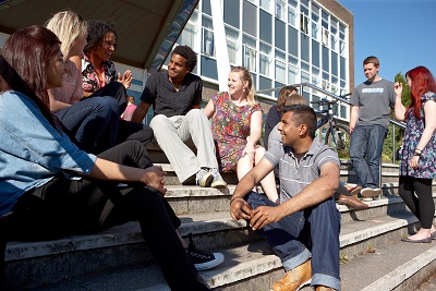 Students chatting on the steps of Grove building