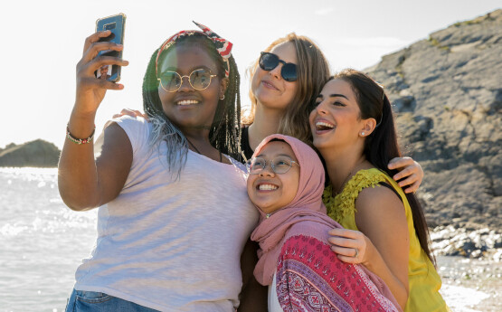 students taking a selfie on the beach