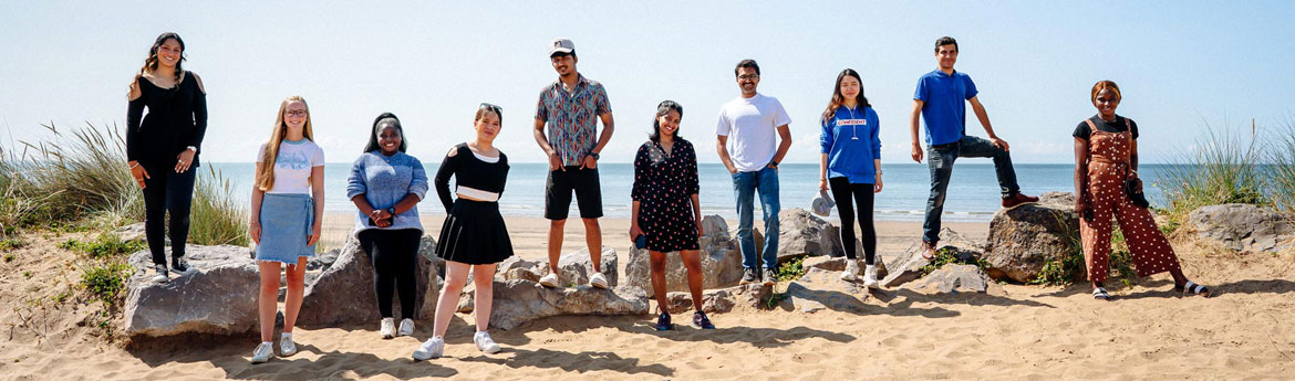 Students standing on the beach