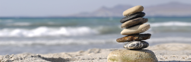 Image of pebbles balancing on beach