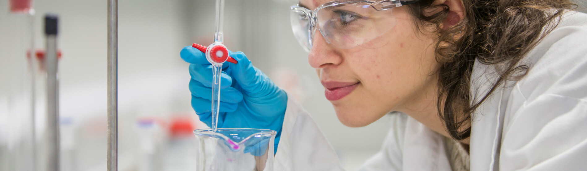 Female scientist examining test tube