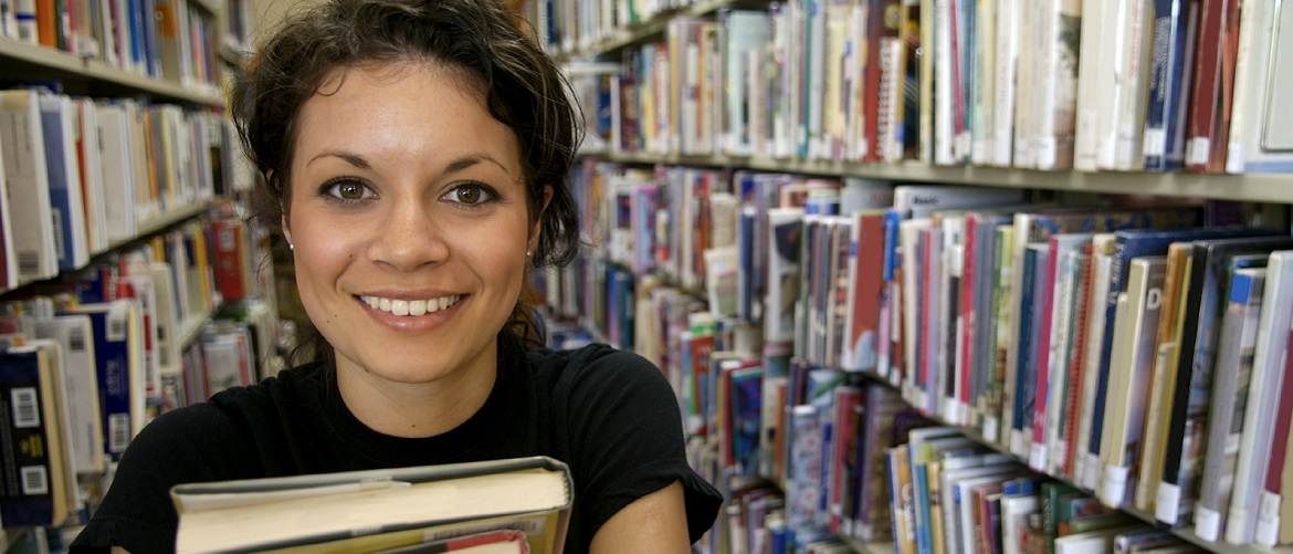 A student holding books at Singleton Park Library