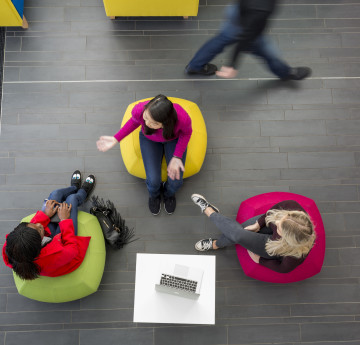 Ariel view of three students chatting. 