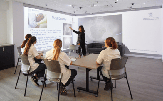 Group of students reviewing a patient history.