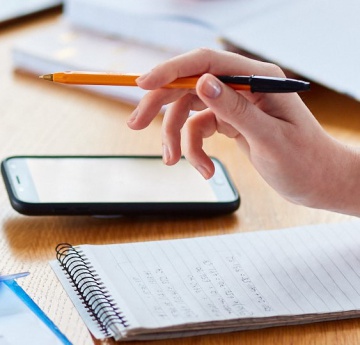 An image of a student taking notes.