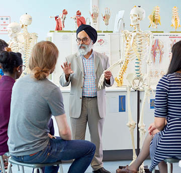 Medical educator teaching anatomy to a group of students