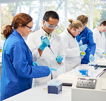 Students in white coats in a teaching laboratory