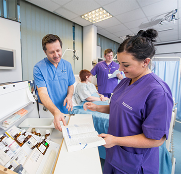 Nursing students review medication records in a clinical skills ward