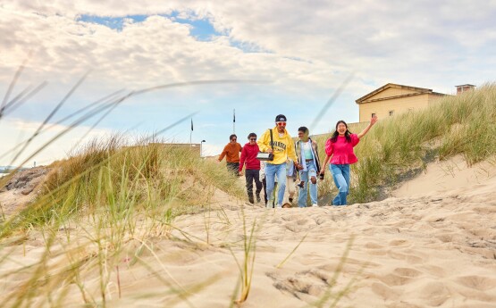 Students walking on the beach