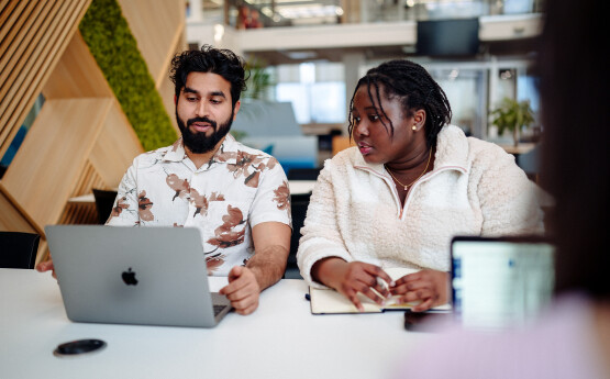 Students looking at a laptop