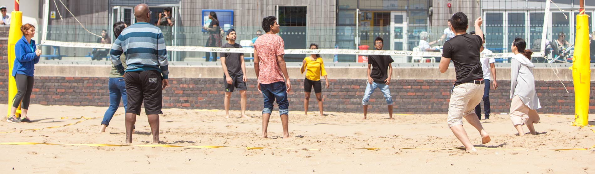 International students playing beach volleyball