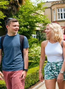 Male and female student walking outside Singleton Abbey