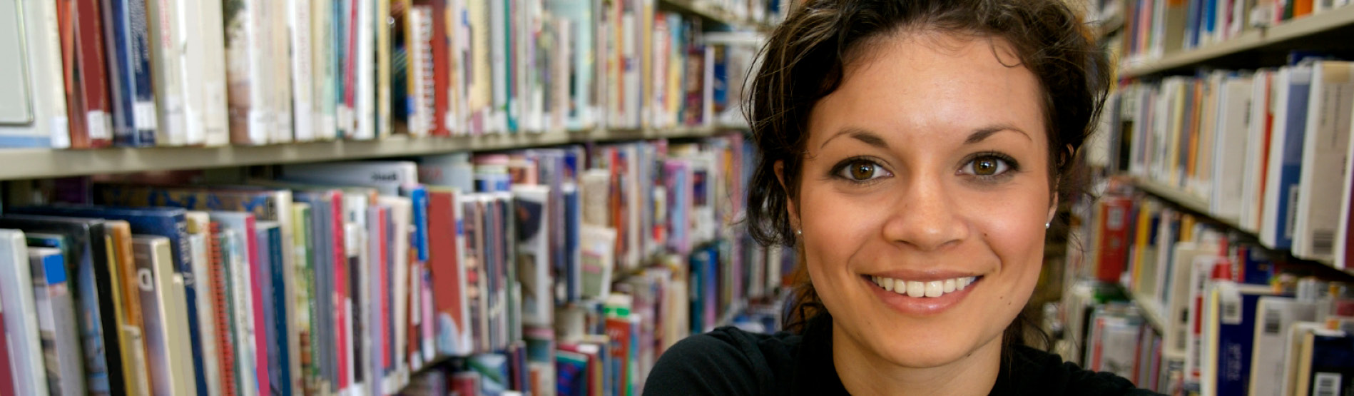 Female student in the library smiling