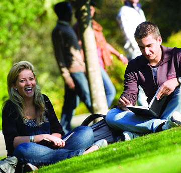 students sitting on the grass