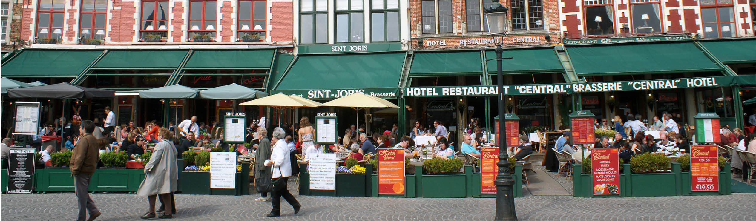 people sitting outside cafes in europe