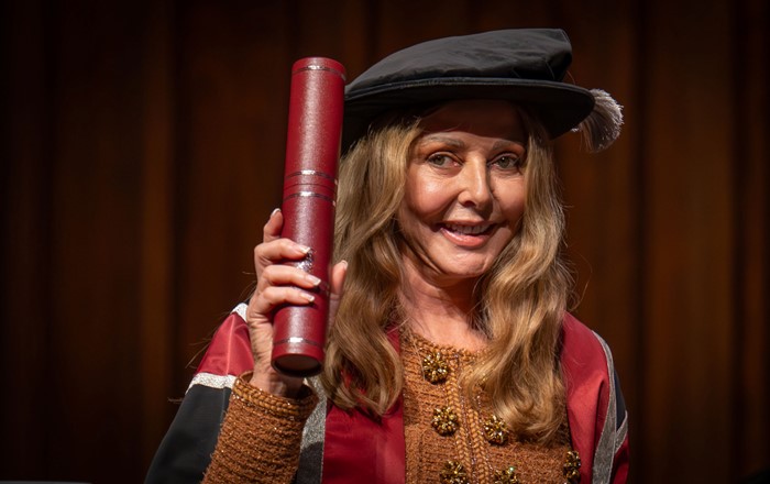 Carol Vorderman poses with Swansea university scroll 