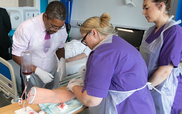 Student nurses demonstrate to Health Minister Vaughan Gething how to take blood using high-tech simulation models during the official opening of the Aneurin Bevan Clinical Skills Centre at Singleton Hospital. 