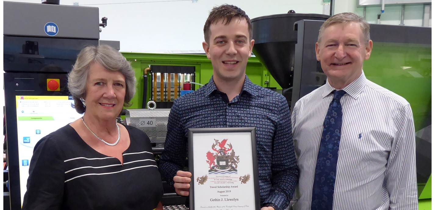 Gethin Llewelyn of Swansea University College of Engineering, being presented with a travel scholarship award by Sylvia Robert-Sargeant and Simon Holt of the Worshipful Livery Company of Wales.