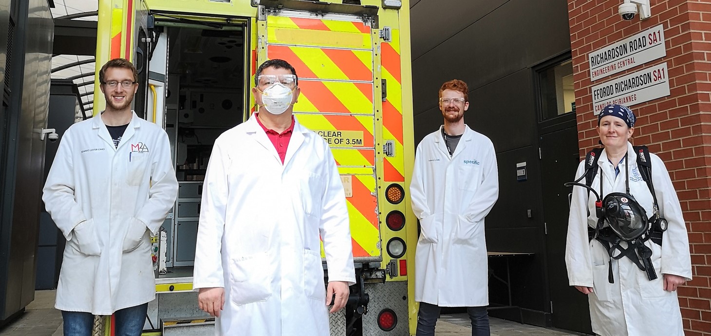 (L-r) Ed Lester-Card, Dr Chedly Tizaoui, Anthony Lewis and Dr Karen Perkins of Swansea University College of Engineering, with the demonstration ambulance used to test out their speed-cleaning procedure