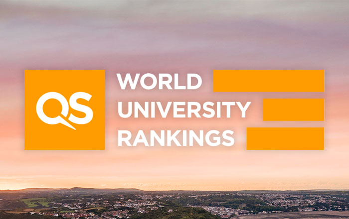 Aerial shot of Swansea with QS World University Rankings in text.