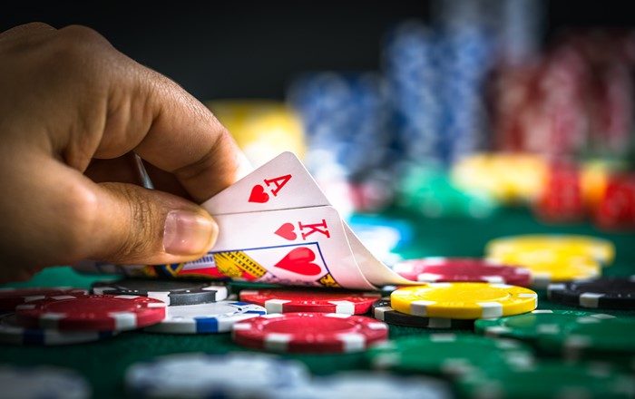 A photo of a person gambling, playing a game of cards.