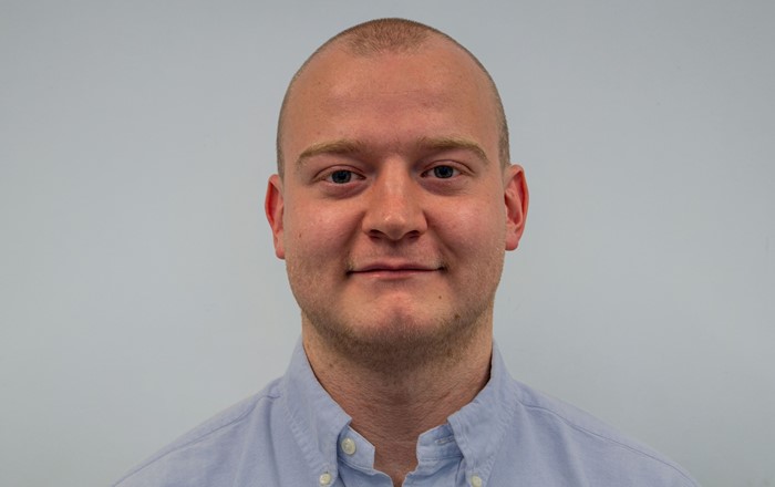 A headshot of Swansea University PhD research student, Thomas Spriggs.