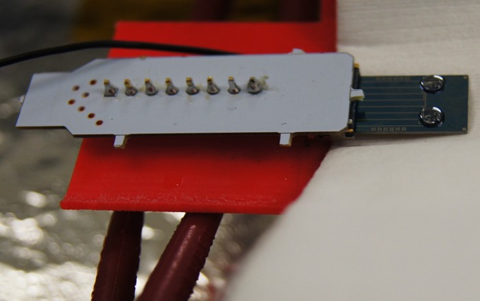 Graphene device chip attached to an electrical connector.