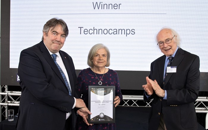 Professor Faron Moller, Director of Technocamps (left), and Beti Williams (centre), Patron, receive the award from Nobel laureate Professor Sir Martin Evans