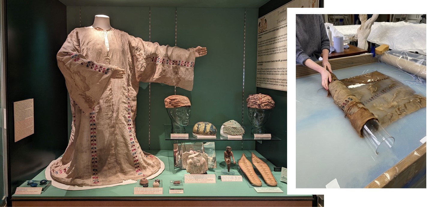 Historical tunic on a mannequin in an exhibition alongside smaller artifacts.