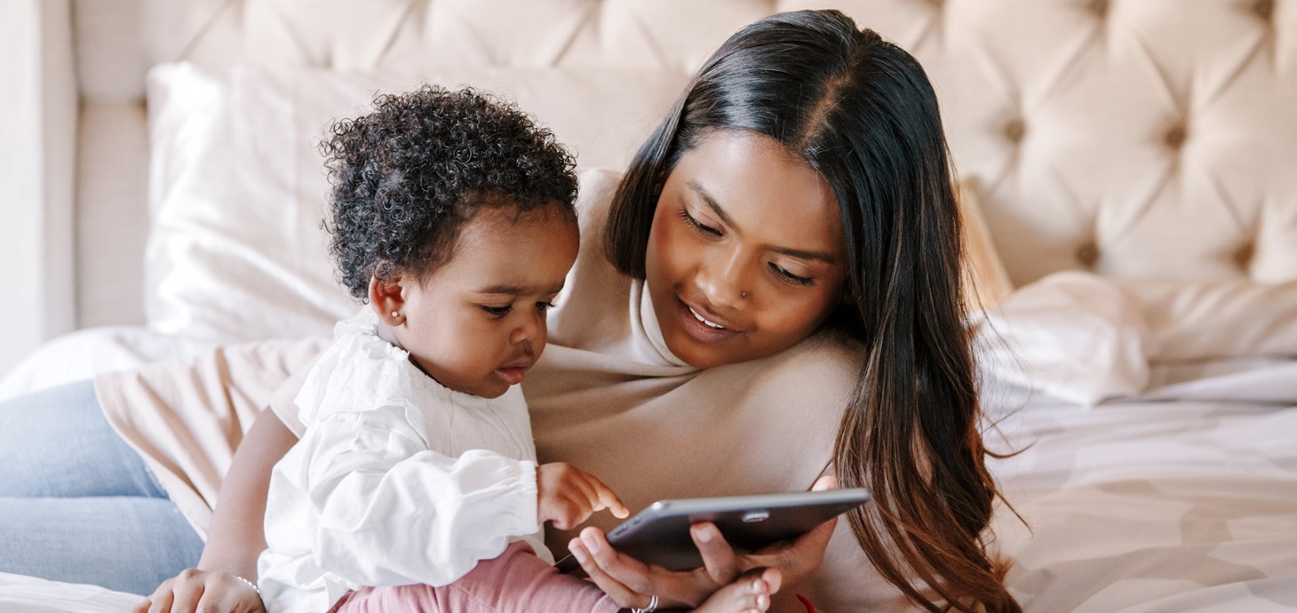 A toddler and mum looking at an iPad