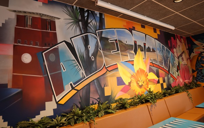 A photo of one of the incredible murals in the Global Lounge. The one in the centre includes the word Abertawe, a daffodil and buildings from both Swansea’s Singleton and Bay campuses.
