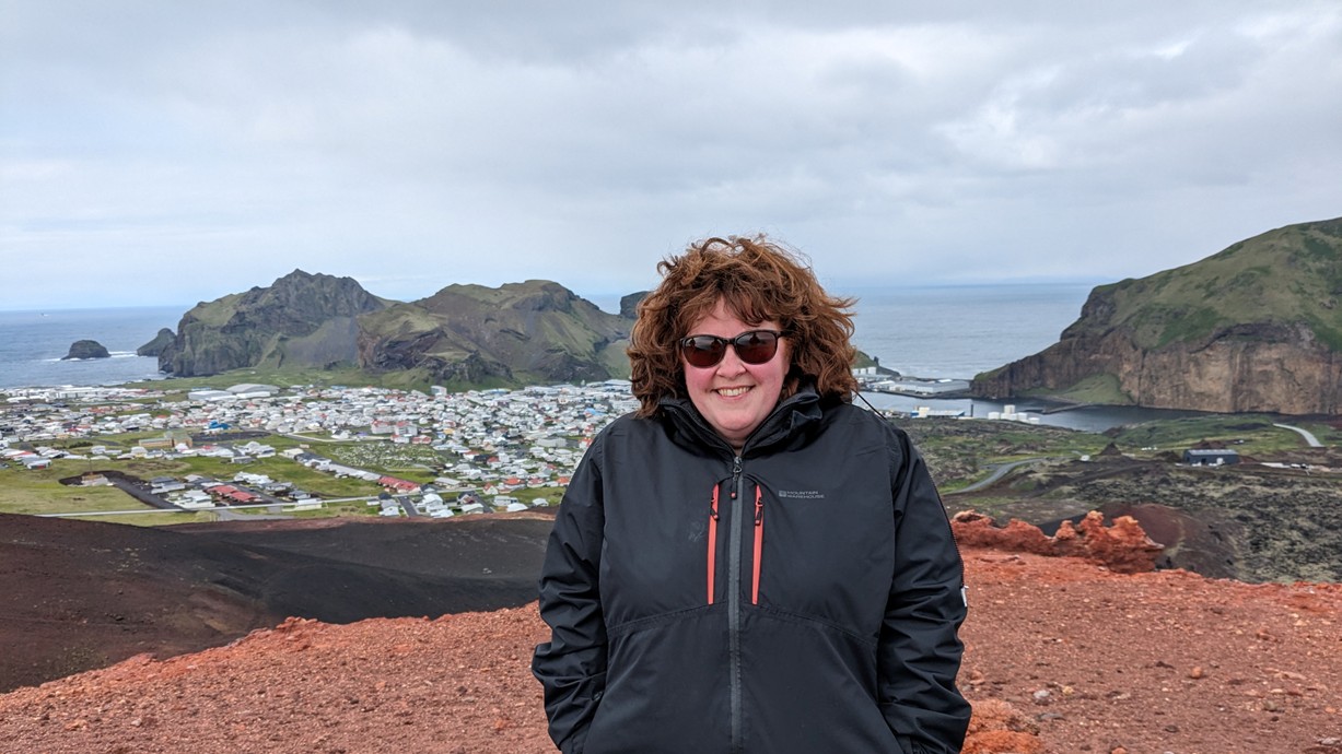 Dr Rhian Hedd Meara standing on Eldfell, the volcano that reshaped Heimaey in 1973, during filming of Isle of Fire.