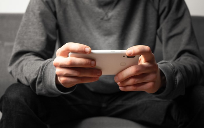 Close-up of a man's hands holding a mobile phone