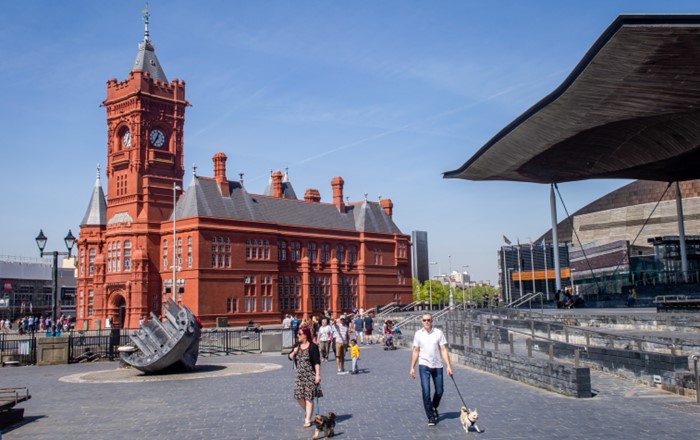 Exterior shot of Cardiff featuring red brick Pierhead Building alongside modern Senedd building