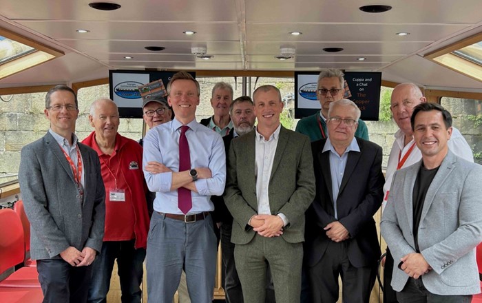 Group of 11 men standing inside a boat