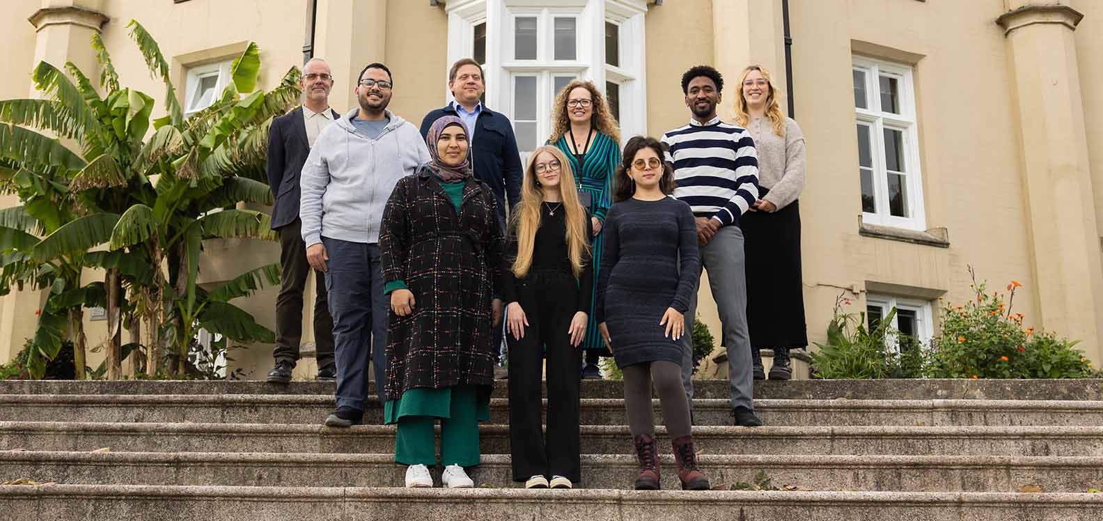 Representatives from Swansea University pictured with international students displaced from their homes by conflict.