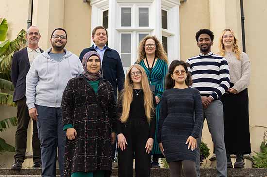 Representatives from Swansea University pictured with international students displaced from their homes by conflict.