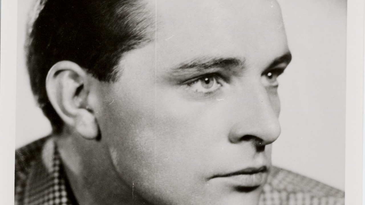 Black and white head and shoulders photo of a young man