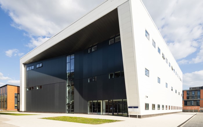 An exterior shot of the CISM building at Swansea University’s Bay Campus. The building is rectangular with black and white cladding.