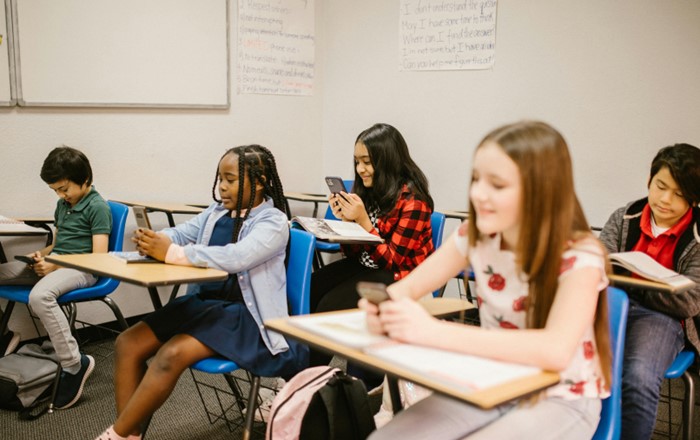 Group of schoolgirls sitting at desks in a classroom