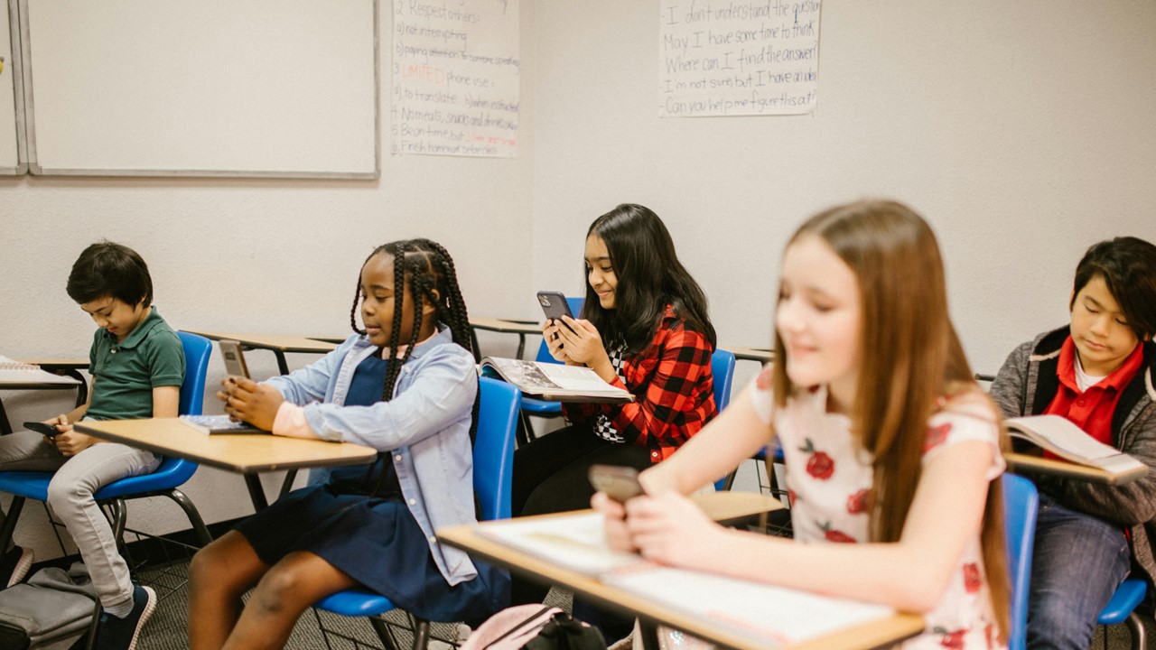 Group of schoolgirls sitting at desks in a classroom