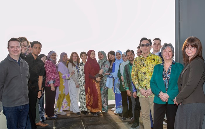 Group of men and woman standing together outside