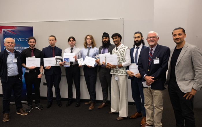 Group of adults in a row holding certificates