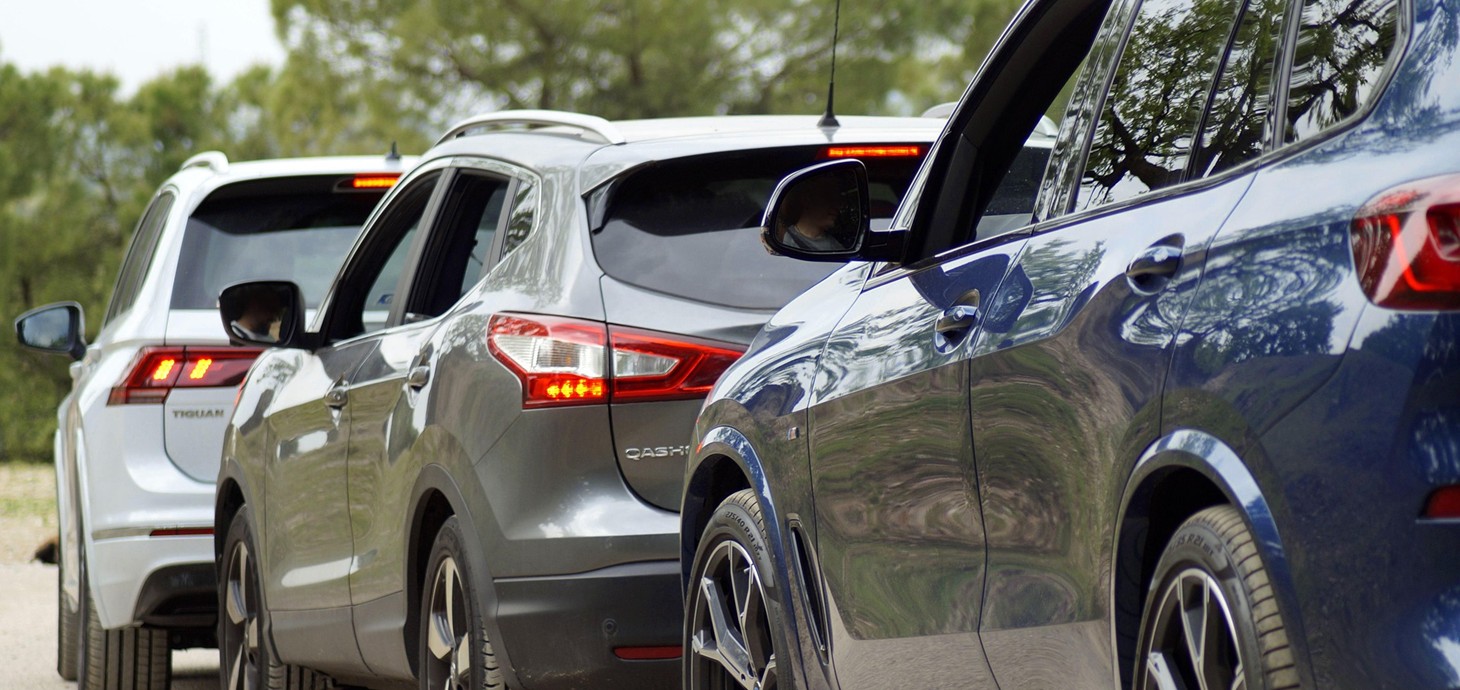 Rear view of three SUV cars in a queue