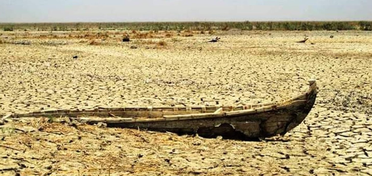 Remains of a boat on a dried-up river bed.