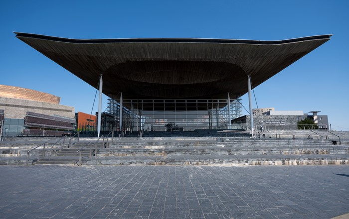 The Senedd building pictured against a blue sky 